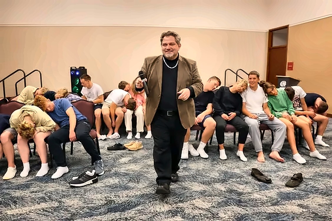 Clean comedy hypnotist Michael Oddo on stage with volunteers