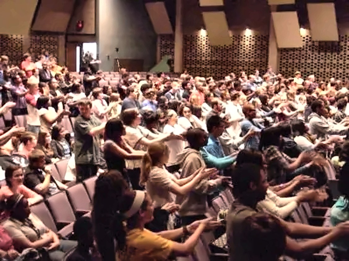Comedy hypnotist Michael Oddo performing for a large Ohio event audience